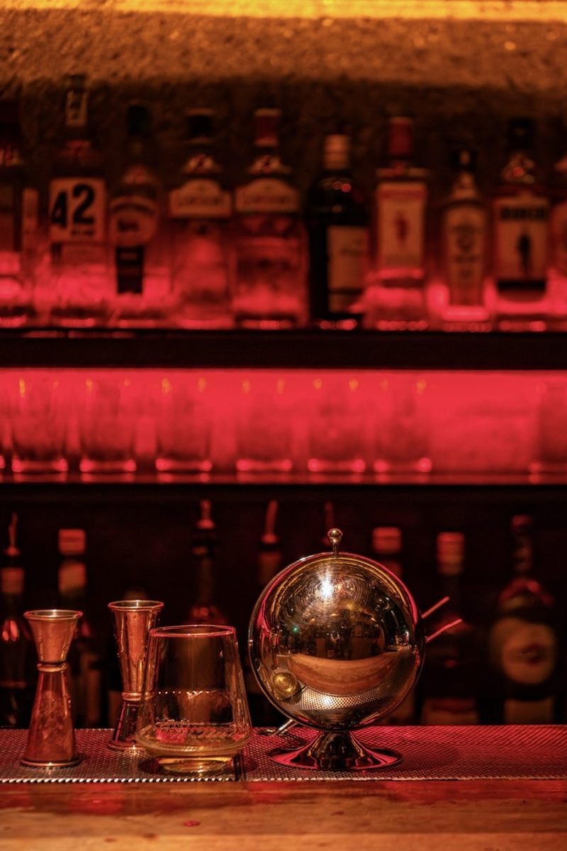 Bar shelf with premium spirits and cocktail tools