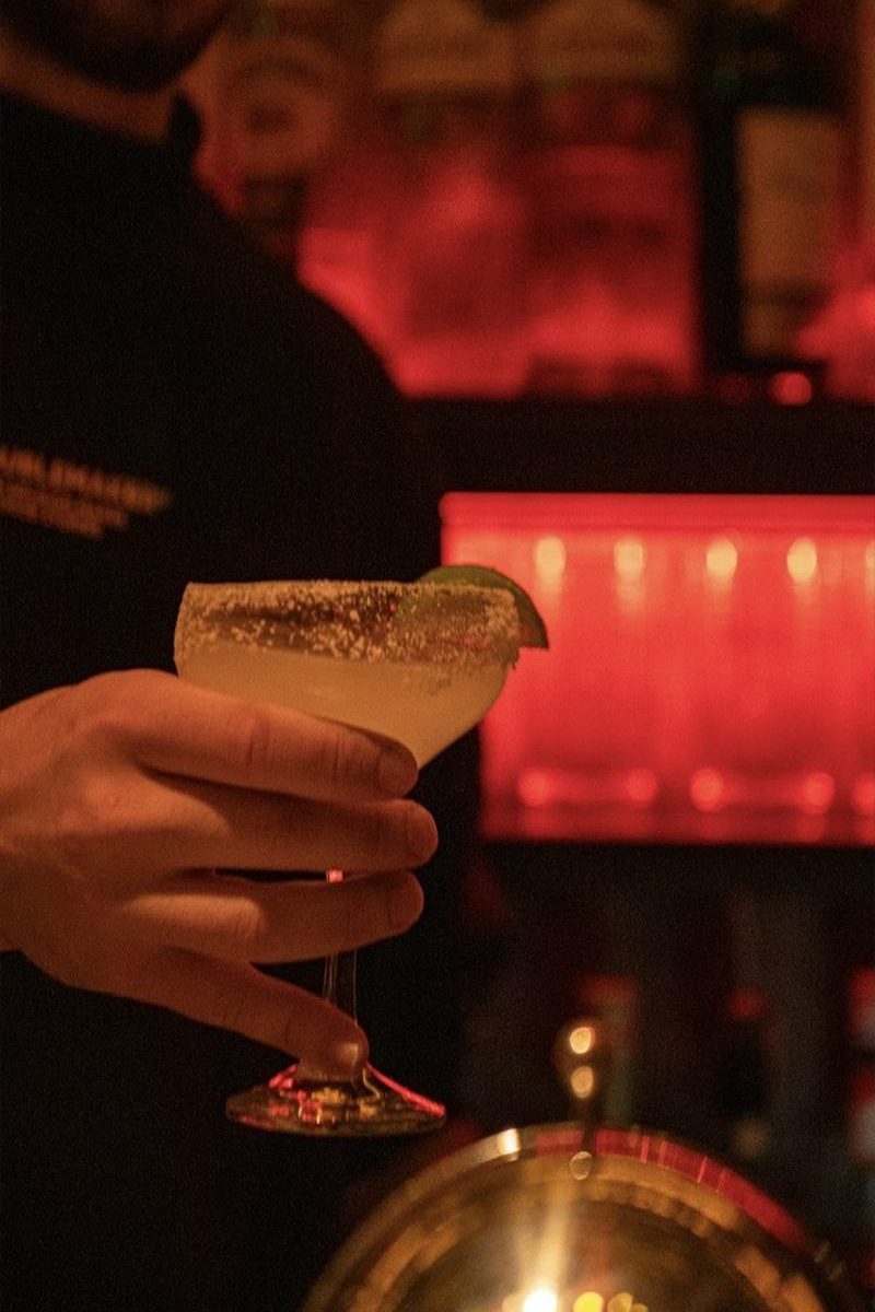 Bartender presenting a craft cocktail